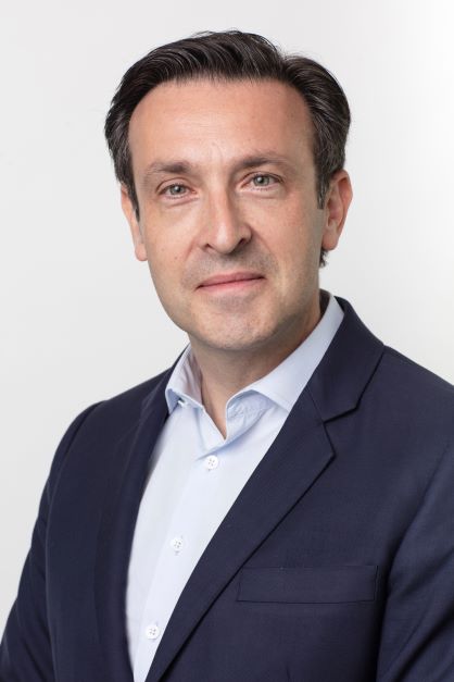 Professional headshot of a man in a suit