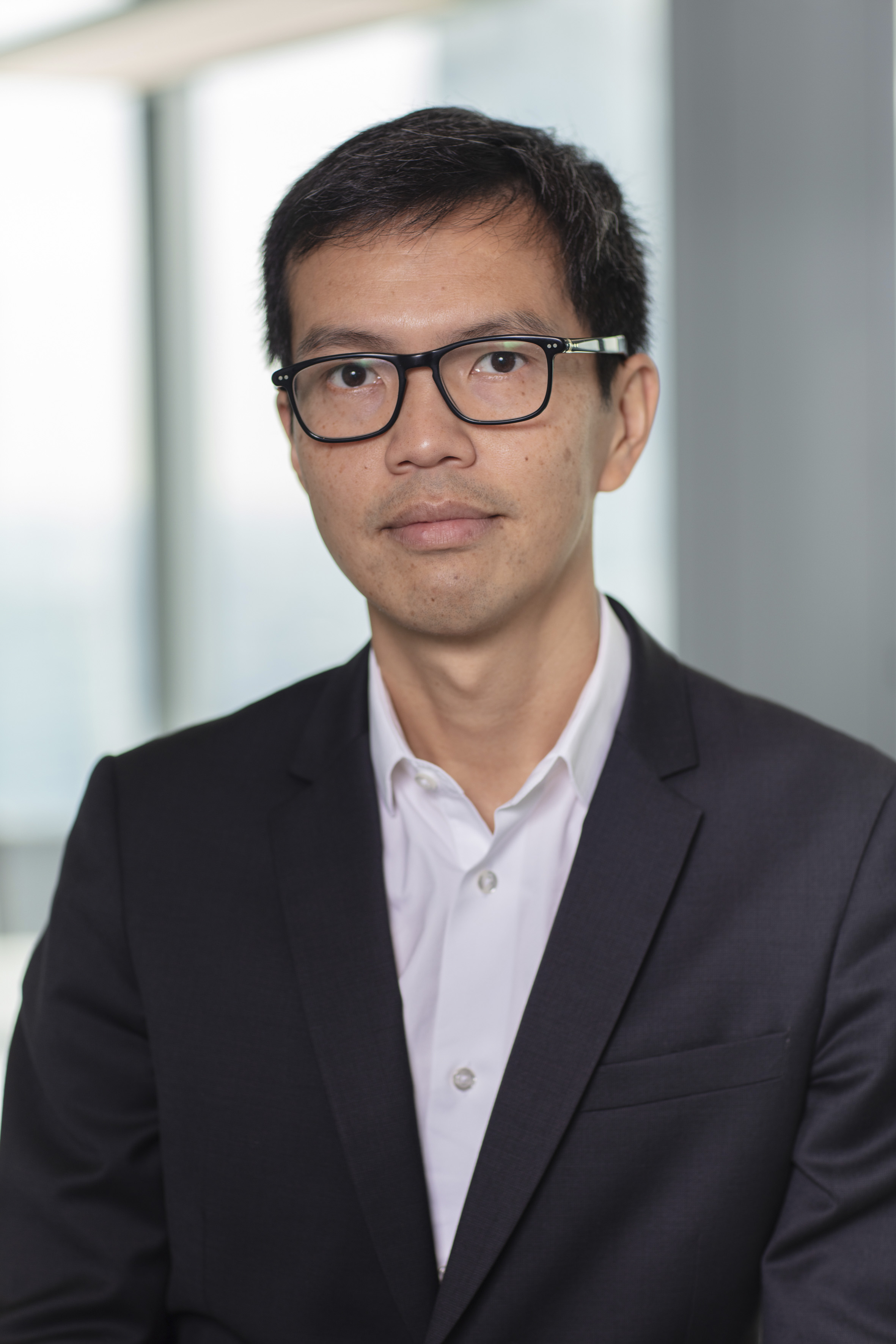 Professional headshot of a man in a suit