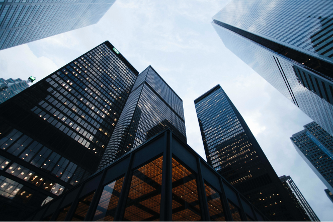 a colourful wide angle shot of skyscrapers from the perspective of the ground.