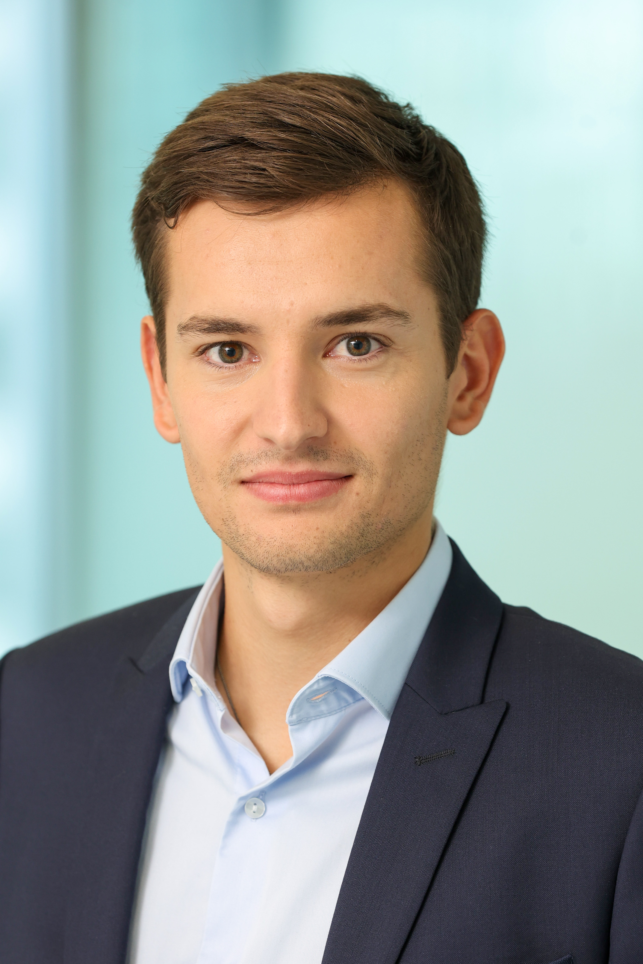 Professional headshot of a man in a suit