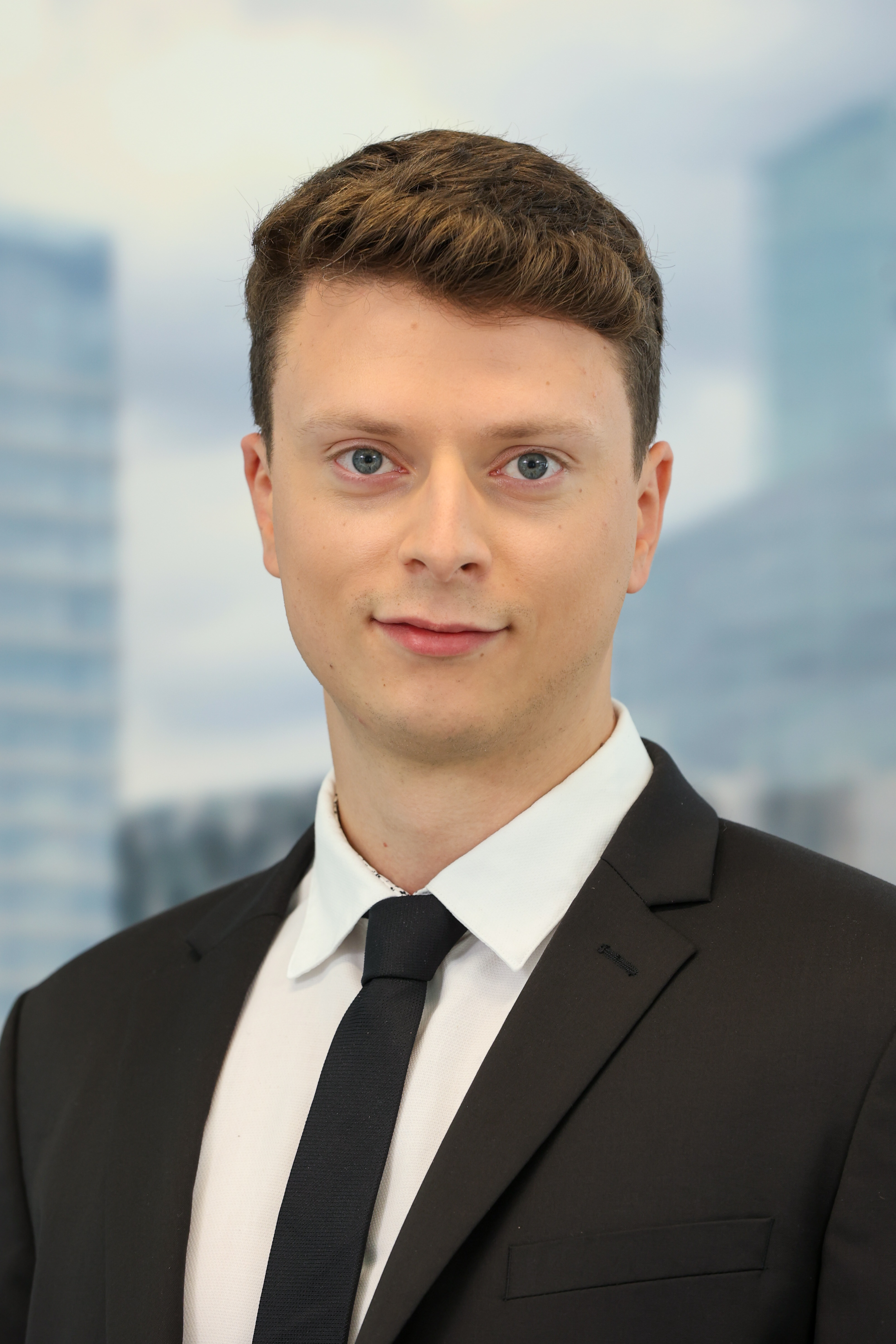 Professional headshot of a man in a suit