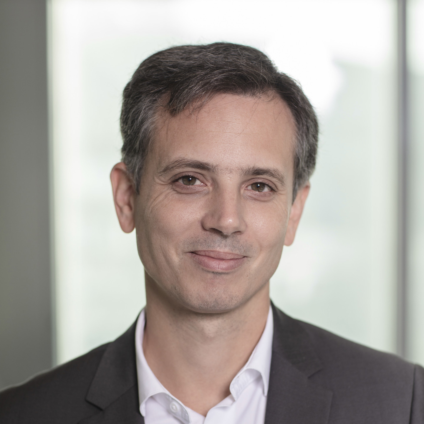 Professional headshot of a man in a suit